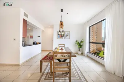a dining room with a table and a window at 1 Br Boho Beach Ain Full Sea View JBR 1 min in Dubai