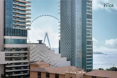 a view of a city with a ferris wheel in the background at 1 Br Boho Beach Ain Full Sea View JBR 1 min in Dubai