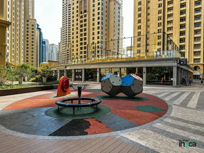 a city square with a sculpture in front of a building at 1 Br Boho Beach Ain Full Sea View JBR 1 min in Dubai