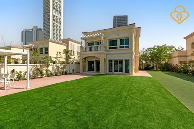 a house with a large yard with green grass at Brand new Large Villa JVT Private Garden in Dubai