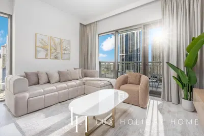 a living room with a couch and a table at LUX The Creekside Skyline View Suite in Dubai