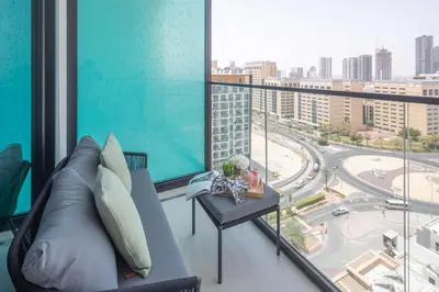 a living room with a couch and a large window at Frank Porter - Binghatti Azure in Dubai