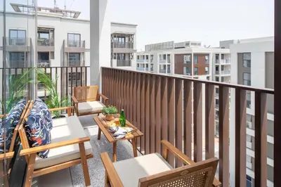 a balcony with tables and chairs on a building at Frank Porter - Lotus at Creek Beach in Dubai