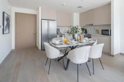 a dining room with a table and chairs in a kitchen at Frank Porter - Lotus at Creek Beach in Dubai