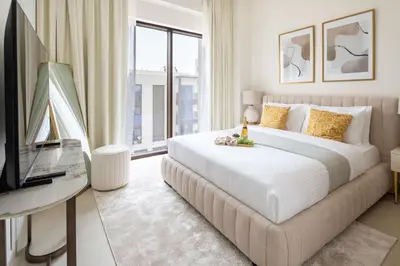 a bedroom with a large bed and a television at Frank Porter - Lotus at Creek Beach in Dubai