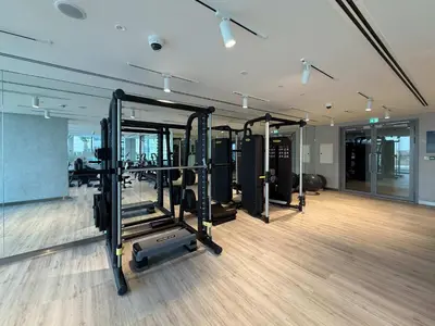 a gym with several tread machines in a room at Frank Porter - Canal Front Residence 9A in Dubai