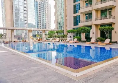 a large swimming pool in the middle of a building at Boulevard Charm- Studio Hideaway in Dubai