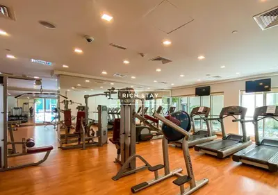a gym with several tread machines in a room at Boulevard Charm- Studio Hideaway in Dubai