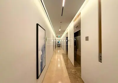 a hallway with white walls and a picture on the wall at Boulevard Charm- Studio Hideaway in Dubai