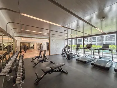 a gym with treadmills and ellipticals in a building at Elegant & Cozy Home with Stylish Modern Interiors in Dubai
