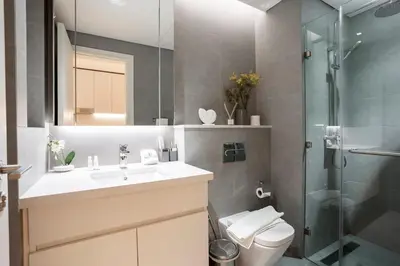 a bathroom with a toilet and a sink and a shower at FIRST CLASS Studio Modern Elegance in Dubai