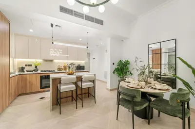 a kitchen and dining room with a table and chairs at FIRST CLASS 1BR Canal Views , Gem of Mayfair in Dubai