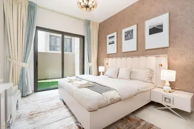 a bedroom with a white bed and a large window at Ahlan HH - 1BR Haven with Study Room - Eleganz by Danube in Dubai