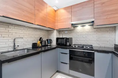 a kitchen with a sink and a stove top oven at Ahlan HH - 1BR Haven with Study Room - Eleganz by Danube in Dubai