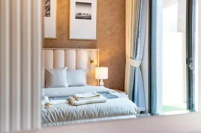 a bedroom with a bed with two towels on it at Ahlan HH - 1BR Haven with Study Room - Eleganz by Danube in Dubai