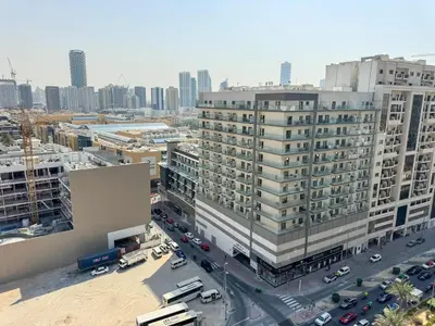 an aerial view of a city with buildings and cars at 1BDR with Gym, Sauna, Pool - Opposite Circle Mall in Dubai