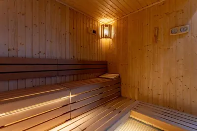 a wooden sauna with a light on the inside at 1BDR with Gym, Sauna, Pool - Opposite Circle Mall in Dubai