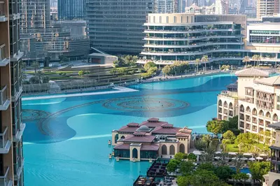a view of a river in a city with buildings at Panoramic Fountain & Burj Khalifa Views, Pool, Gym in Dubai