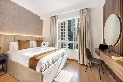 a hotel room with a bed and a mirror at Panoramic Fountain & Burj Khalifa Views, Pool, Gym in Dubai