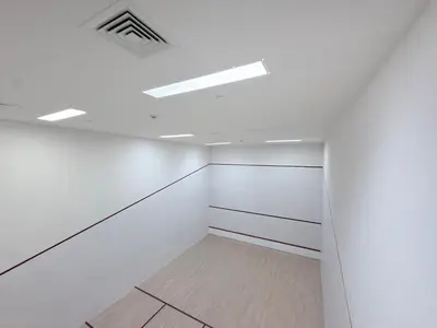 an empty room with white walls and skylights at Panoramic Fountain & Burj Khalifa Views, Pool, Gym in Dubai