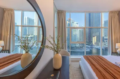 a hotel room with two beds and a mirror at ShoresInn -Waterfront Bliss in Dubai Marina in Dubai