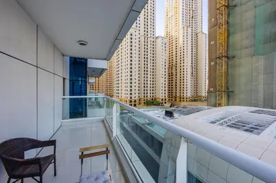 a balcony with a chair and a view of buildings at ShoresInn -Waterfront Bliss in Dubai Marina in Dubai