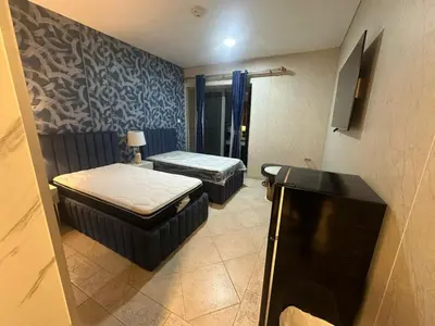 a small room with two beds and a television at Private Room Steps from Jumeriah Beach & Marina Walk - LMY Sadaf 7 JBR Dubai in Dubai