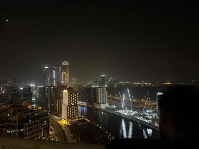 a city skyline at night with a river and buildings at Elegant Urban Escape in Dubai
