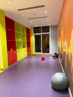 a room with colorful walls and animals sitting on the floor at Bright And Spacious Canal View Appartment in Dubai