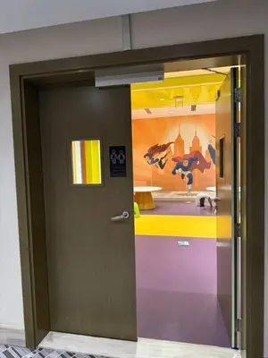 a door in a room with a painting on the wall at Bright And Spacious Canal View Appartment in Dubai
