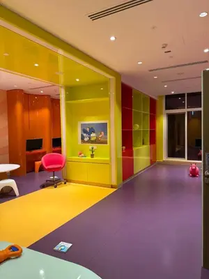 a brightly colored room with a chair and a table at Studio With Canal View in Dubai