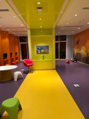a yellow room with a yellow floor and a table and chairs at Studio With Canal View in Dubai