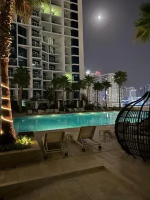 a swimming pool in front of a large building at Studio With Canal View in Dubai