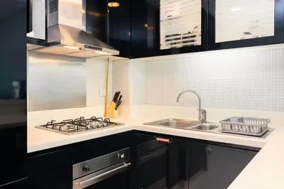 a kitchen with a sink and a stove top oven at CitiHome - Elegant 1BR - Bay View - Prime Location in Dubai