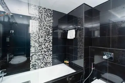 a black bathroom with a tub and a toilet at CitiHome - Elegant 1BR - Bay View - Prime Location in Dubai