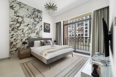 a bedroom with a bed and a large window at Stylish 1BR with PS5, Sauna and Kids' Play Area in Dubai