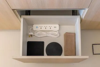 a box with a controller and other items in it at Stylish 1BR with PS5, Sauna and Kids' Play Area in Dubai