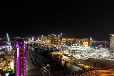 a view of a city at night with lights at Marina 2BR with 31st-Floor Ocean View in Dubai