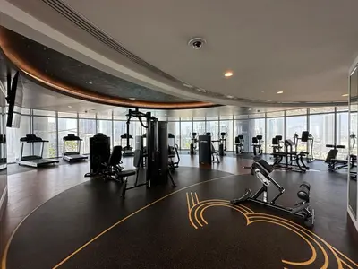 a gym with treadmills and exercise equipment in a building at IMPERIAL AVENUE Brand New Ultra Luxury Full Downtown, Old Town & Burj Khalifa Amazing View! Unforgettable Stay! in Dubai