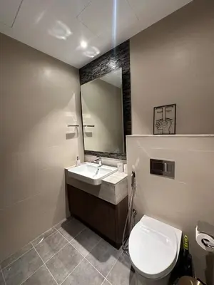a bathroom with a toilet and a sink and a mirror at IMPERIAL AVENUE Brand New Ultra Luxury Full Downtown, Old Town & Burj Khalifa Amazing View! Unforgettable Stay! in Dubai