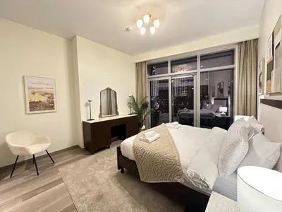 a bedroom with a bed and a desk and a sink at IMPERIAL AVENUE Brand New Ultra Luxury Full Downtown, Old Town & Burj Khalifa Amazing View! Unforgettable Stay! in Dubai