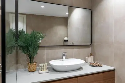 a bathroom with a sink and a mirror at Maison Privee - Dazzling Downtown Retreat with Panoramic City Views in Dubai