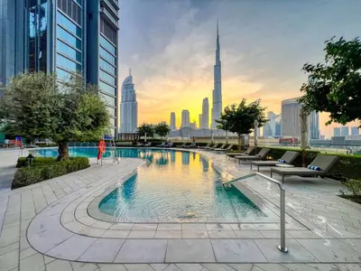a swimming pool with a city skyline in the background at 3BR in Vida Dubai Mall with Stunning Burj Khalifa View in Dubai