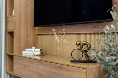 a shelf with a tv and a statue of a bike on it at 3BR in Vida Dubai Mall with Stunning Burj Khalifa View in Dubai