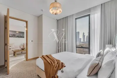 a bedroom with a bed and a large window at 3BR in Vida Dubai Mall with Stunning Burj Khalifa View in Dubai