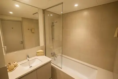 a bathroom with a tub and a sink and a shower at Luxury Stay - Dubai Creek Harbour - Branded Living - Burj View in Dubai