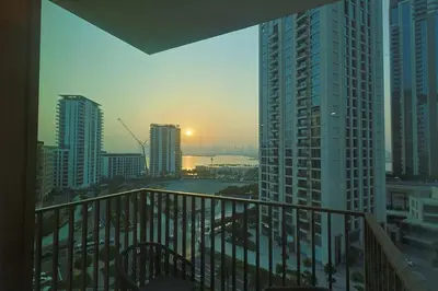 a balcony with a view of a city with tall buildings at Luxury Stay - Dubai Creek Harbour - Branded Living - Burj View in Dubai