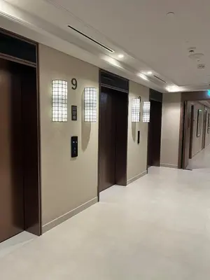 a hallway with brown doors and tile floors at Luxury Stay - Dubai Creek Harbour - Branded Living - Burj View in Dubai