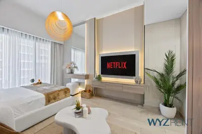 a hotel room with a bed and a tv at Newly Listed Airy Boho Studio Azizi Riviera 26 in Dubai