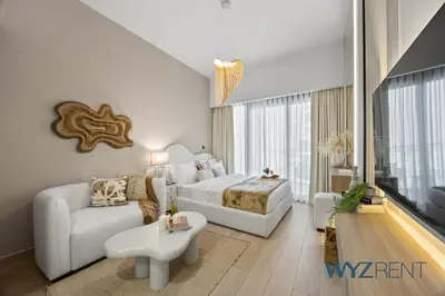 a bedroom with a king sized bed and a couch at Newly Listed Airy Boho Studio Azizi Riviera 26 in Dubai